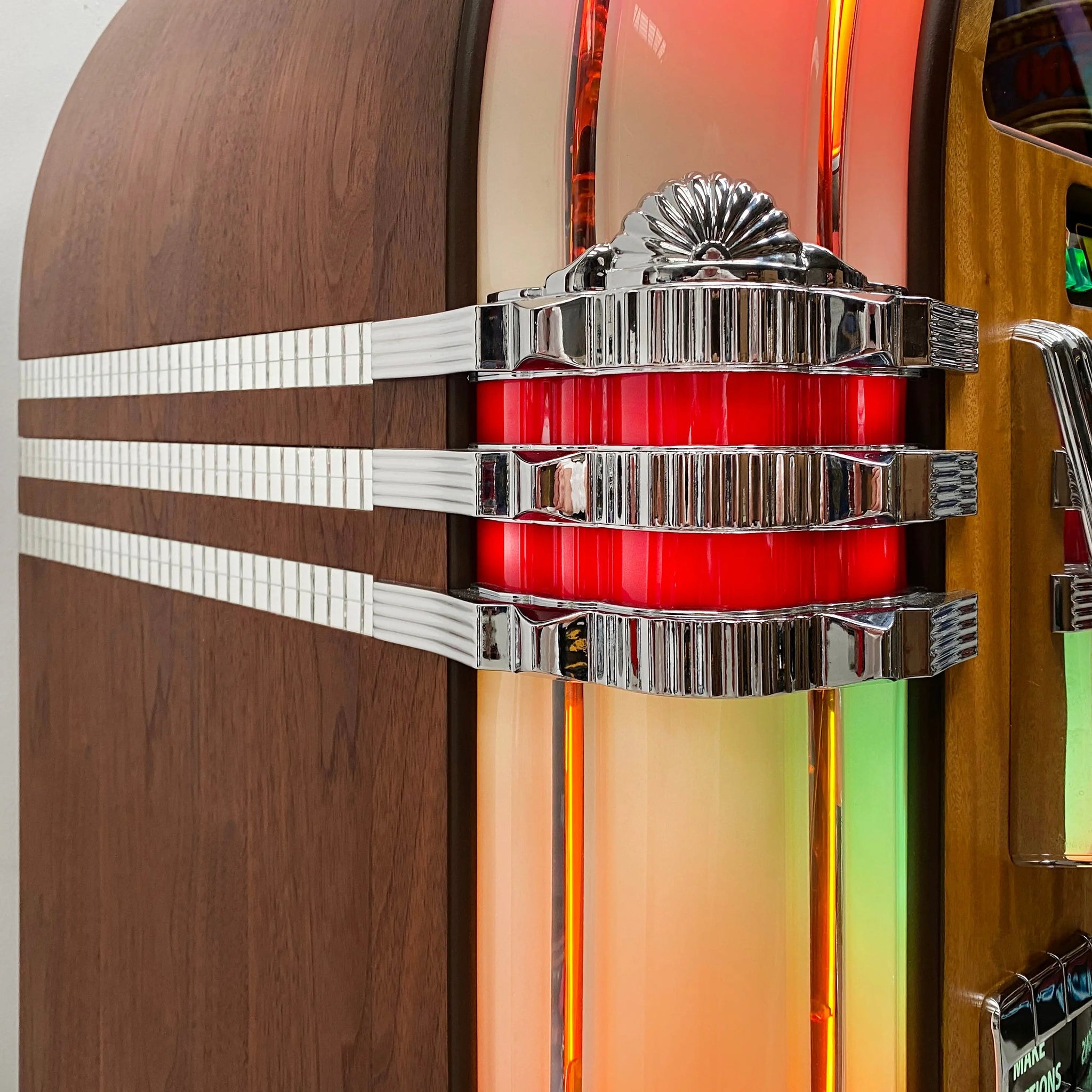 A close up image of the Side Castings and Mirror tiles on Rock-Ola Bubbler Vinyl Deluxe Jukebox